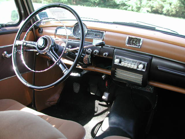 The Spartan interior of the Type 190 Ponton sedan features a modest wood